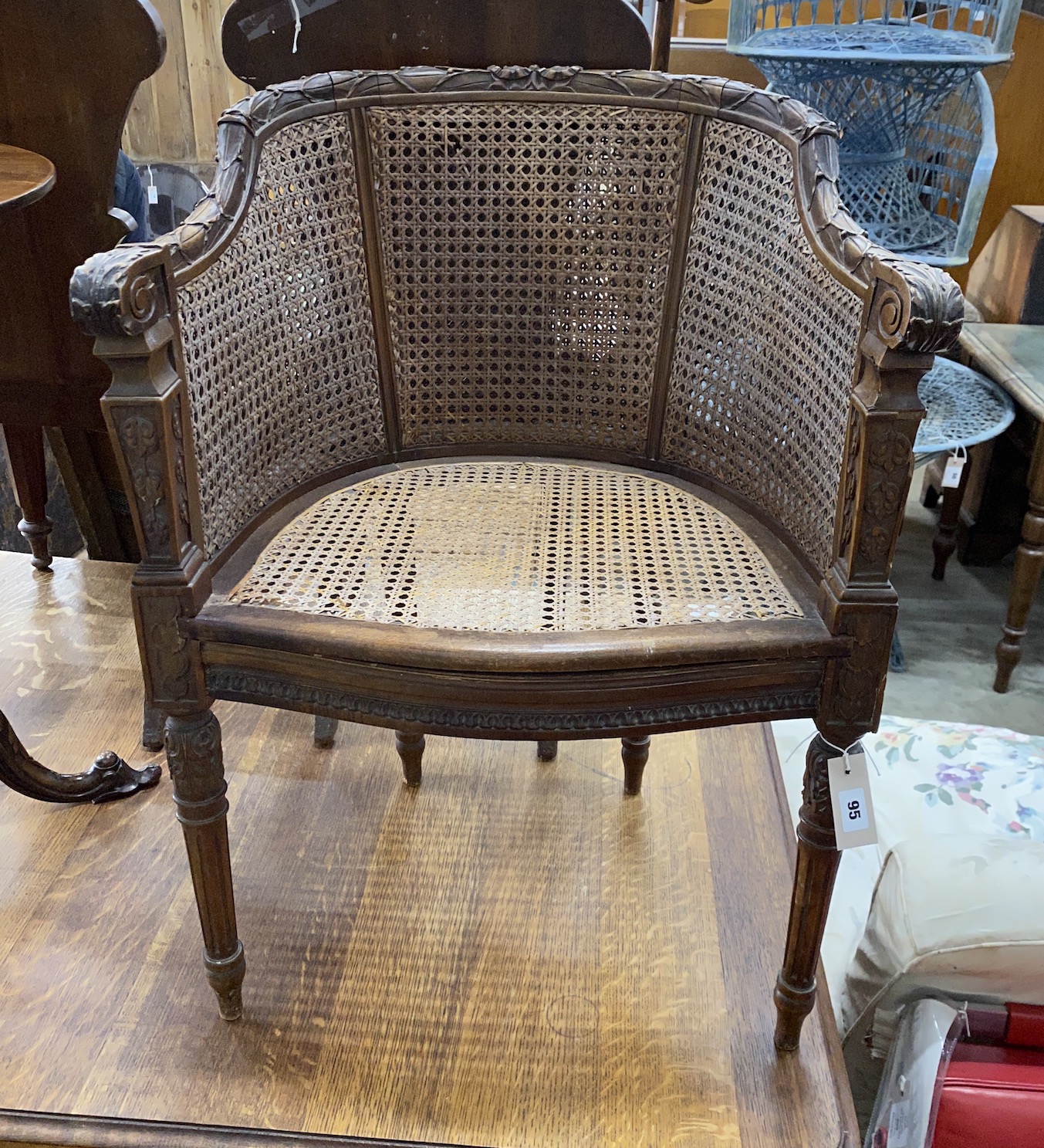A Louis XVI style caned walnut Bergere chair, width 57cm, depth 44cm, height 79cm